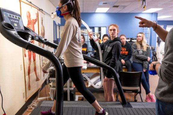 Female walking on treadmill.