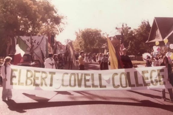Archive photo of students holding an Elbert Covell College banner