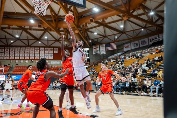 Pacific men's basketball player drives to the basket