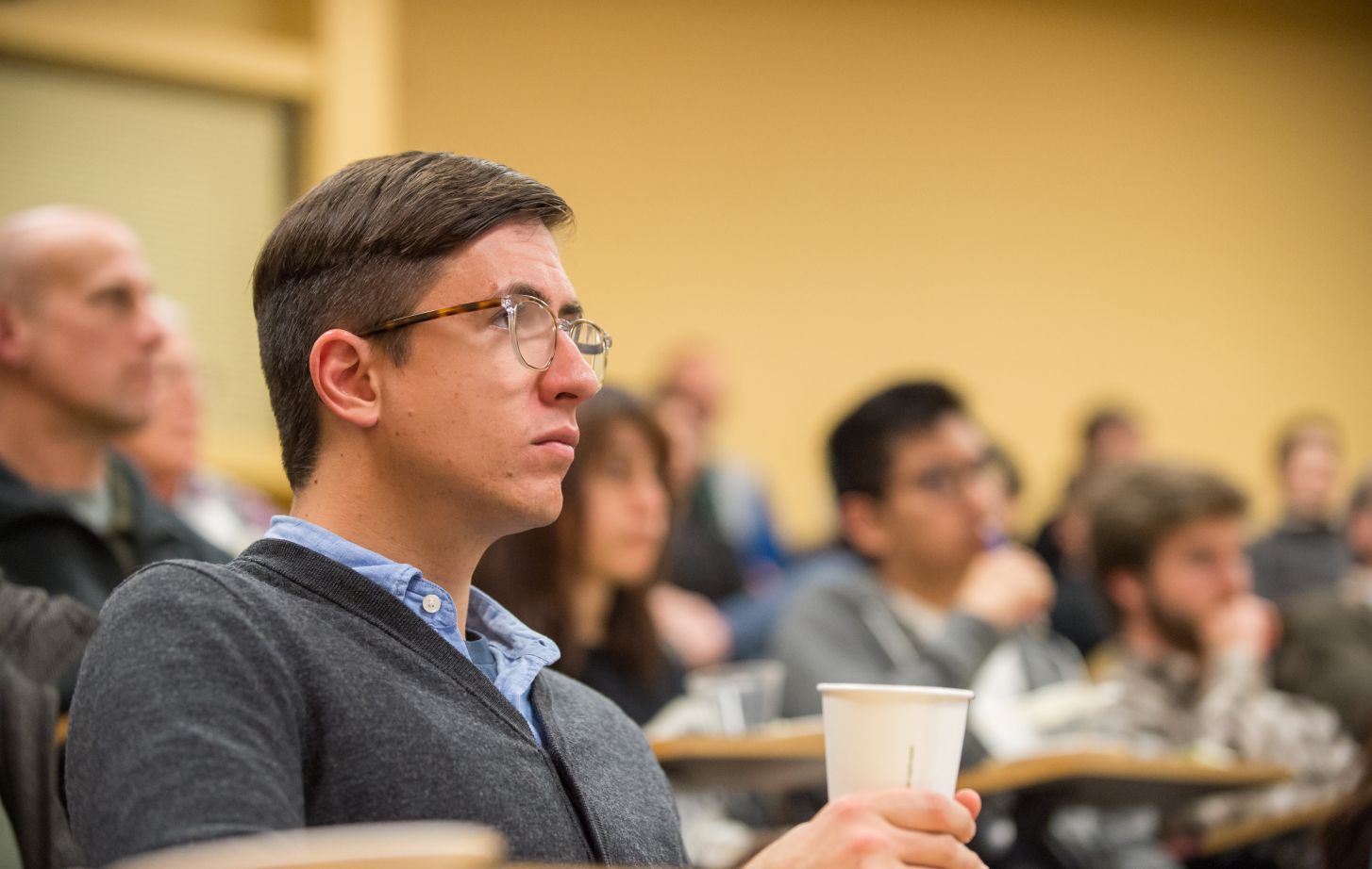 Students sit in a lecture hall