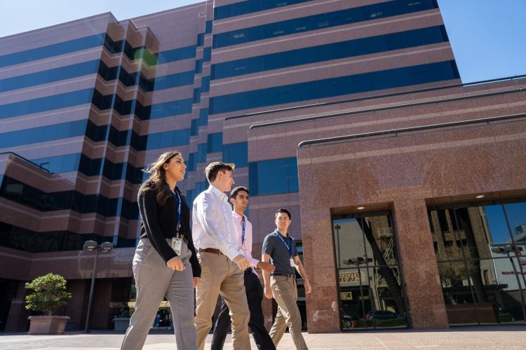 Four students walking in front of Stockton city building