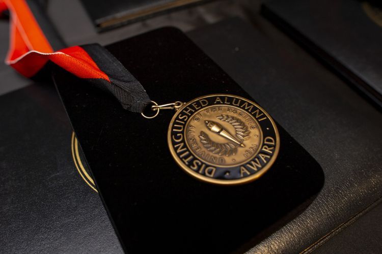 medal reading Distinguished Alumni Award