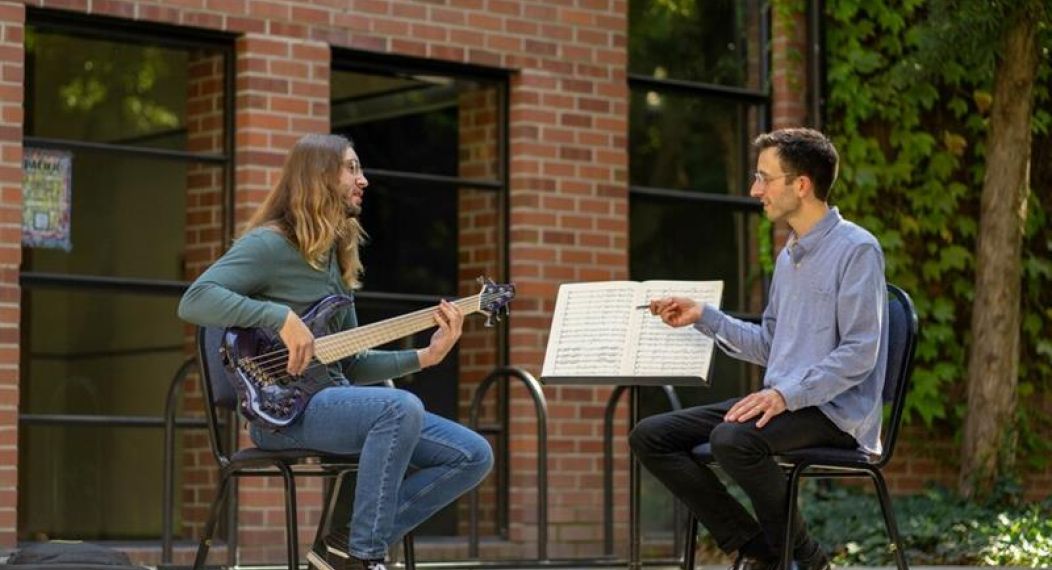 a guitar lesson takes place outside