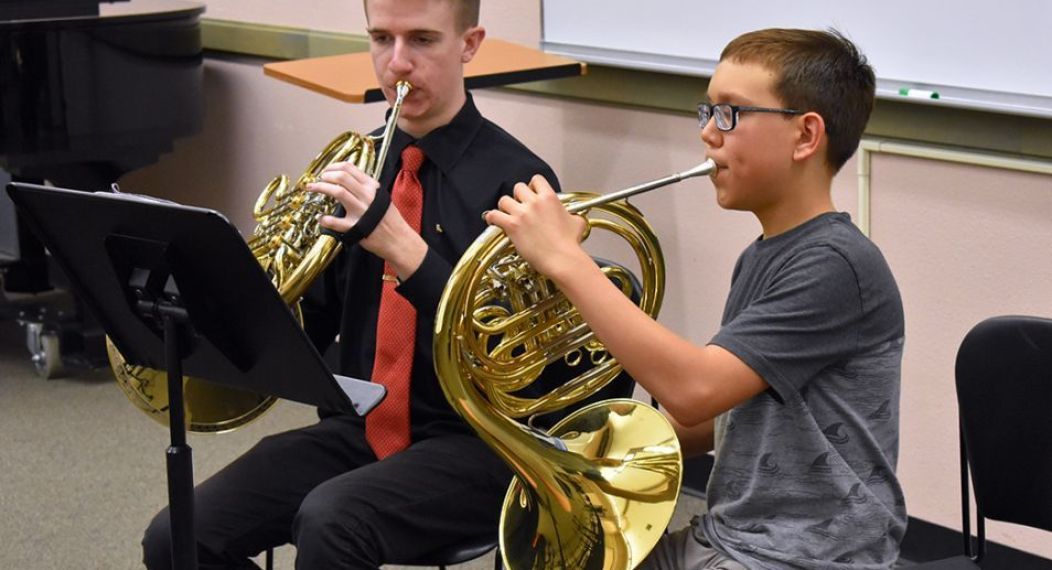two music students practicing the horn