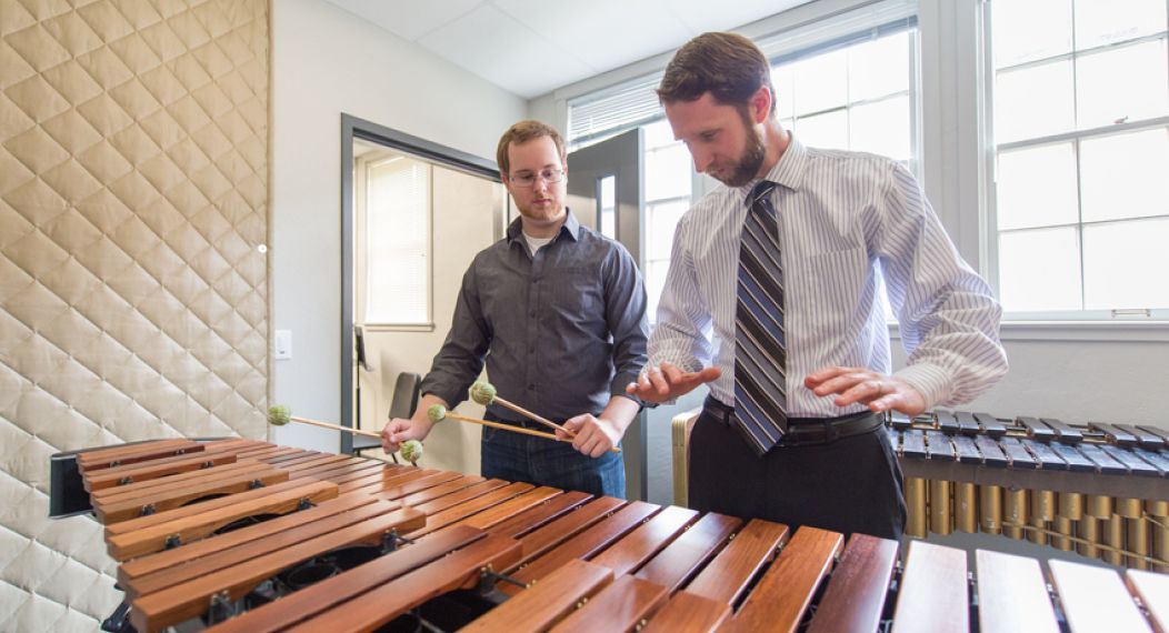 Professor and student playing the marimba