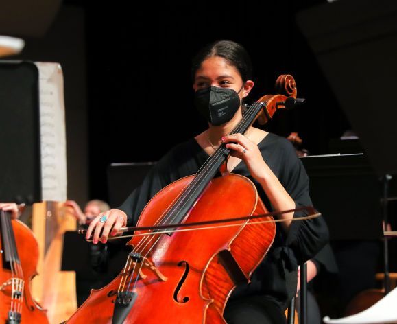 a performer plays the cello
