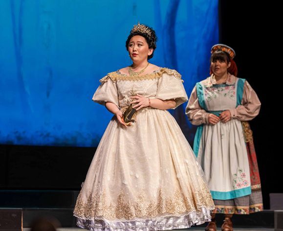 Student actor on stage as Cinderella